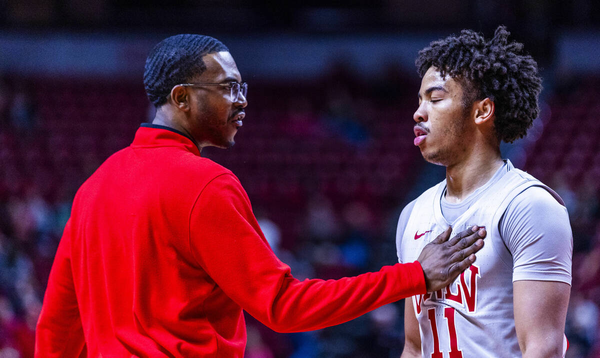 UNLV guard Dedan Thomas Jr. (11) is calmed down by a coach during a time out against the Utah S ...