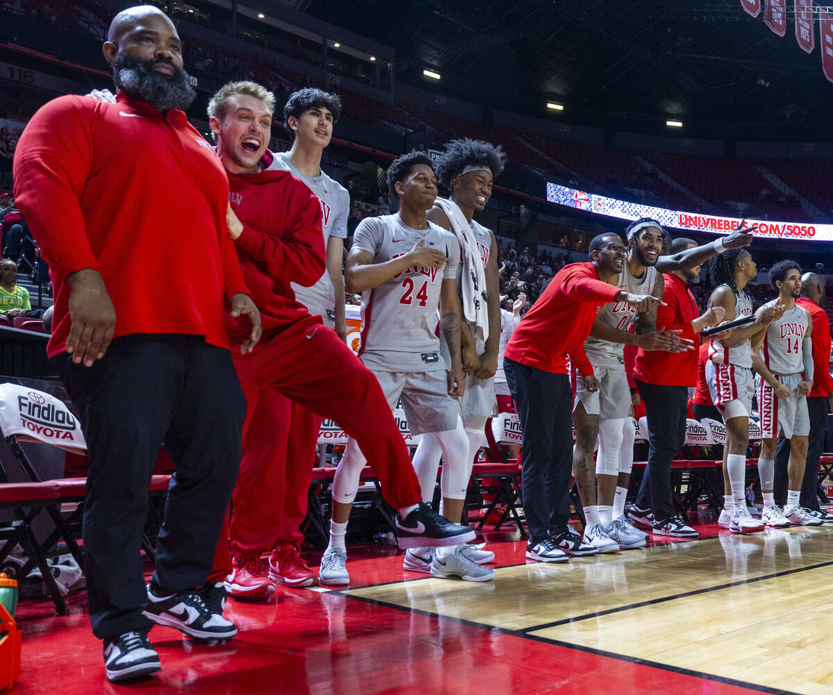 The UNLV bench cheers the team on against the Utah State Aggies during the second half of their ...