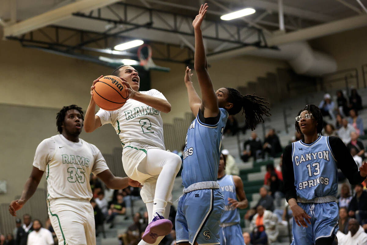 Rancho guard Jakoi Lide (2) shoots against Canyon Springs guard Henry King (14) during the firs ...