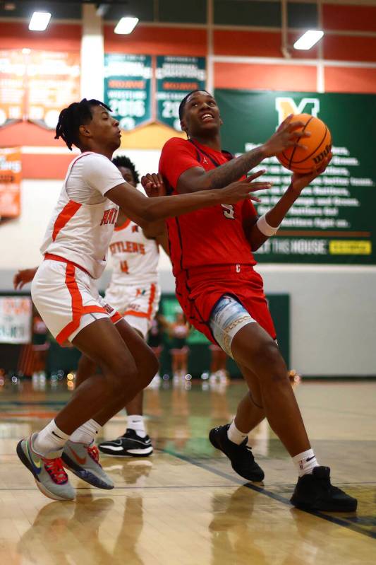 Coronado's Lantz Stephenson (5) drives toward the hoop against Mojave guard Zacarrion Jackson ( ...