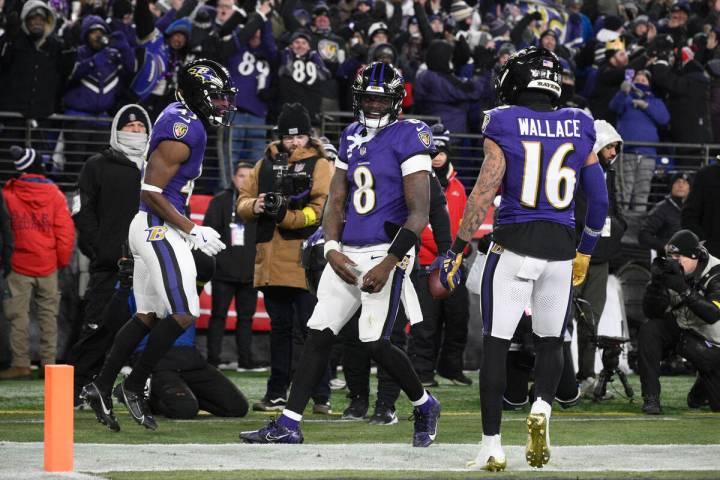 Baltimore Ravens running back Justice Hill (43) celebrates his touchdown with quarterback Lamar ...