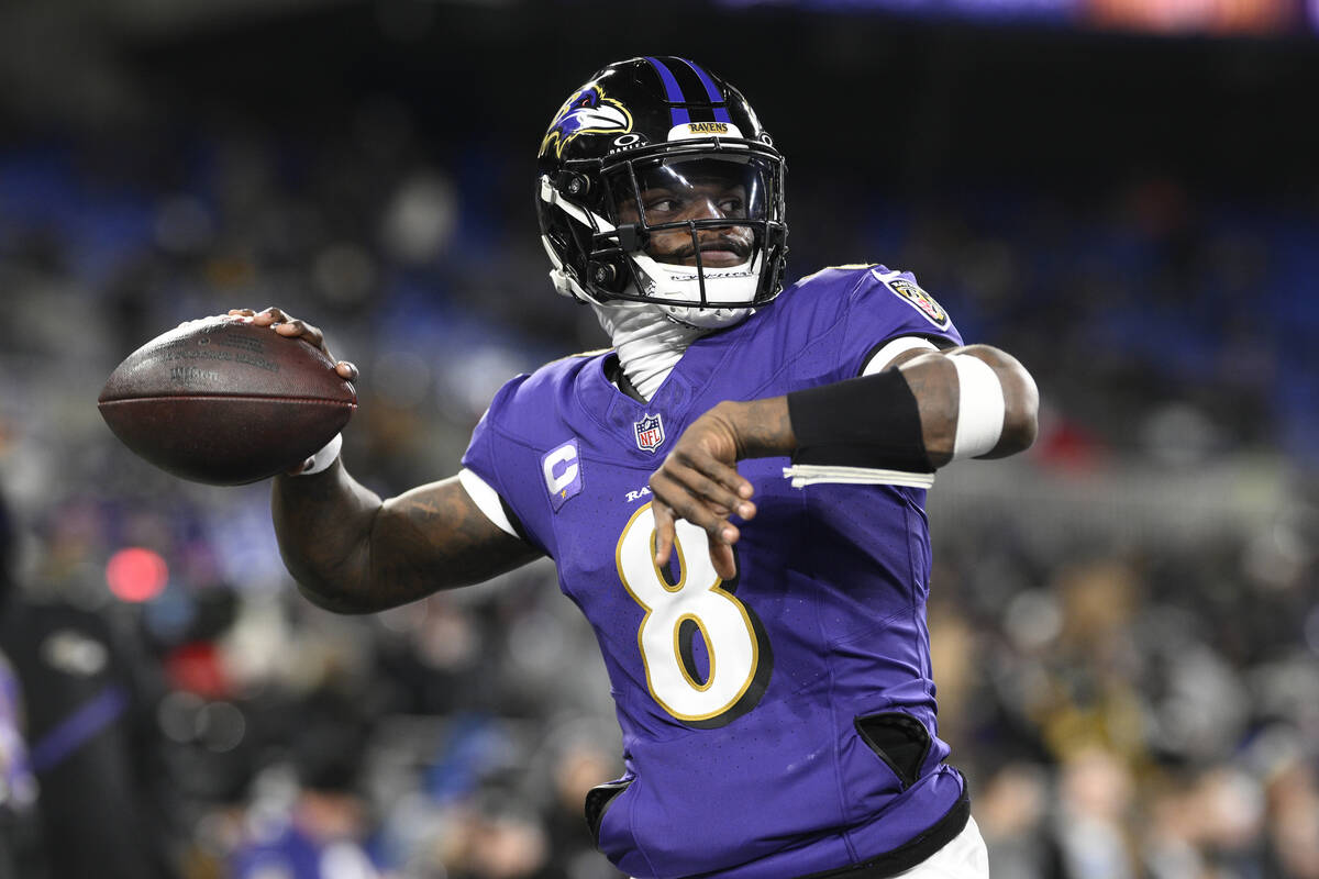 Baltimore Ravens quarterback Lamar Jackson (8) works out before an NFL football wild card playo ...