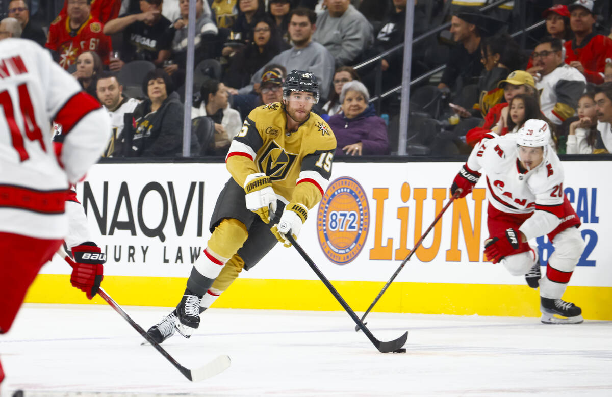 Golden Knights defenseman Noah Hanifin (15) skates with the puck against the Carolina Hurricane ...