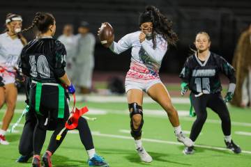 Liberty quarterback/wide receiver Jianna Reyes (12) flips with the ball during a run at a high ...