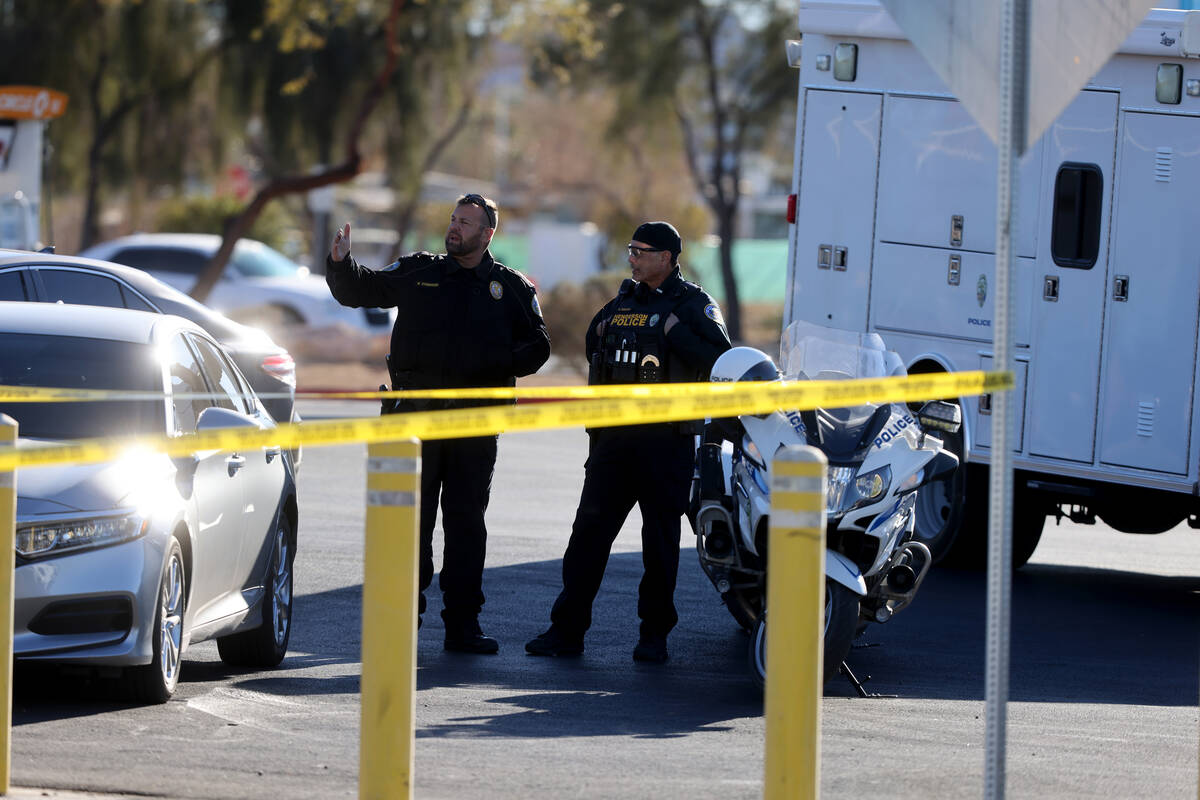 Henderson Police investigate the scene of an officer involved shooting that injured an officer ...