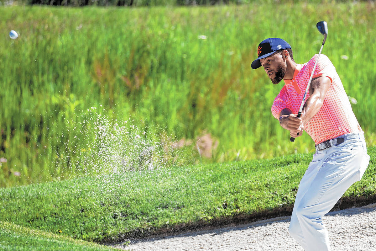 Stephen Curry watches a shot from a bunker on the first hole during the first round of the Amer ...