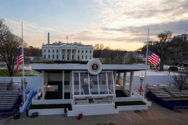 Workers continue with the finishing touches on the presidential reviewing stand on Pennsylvania ...