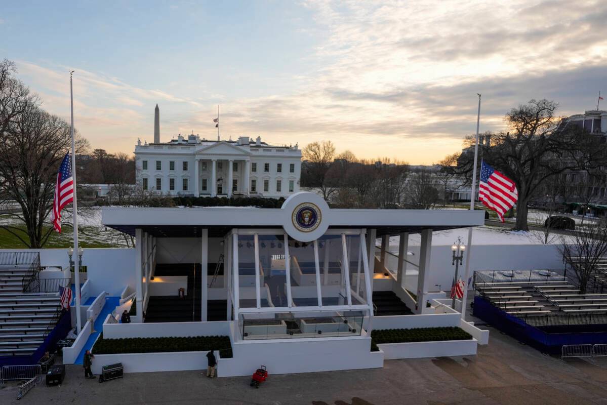 Workers continue with the finishing touches on the presidential reviewing stand on Pennsylvania ...