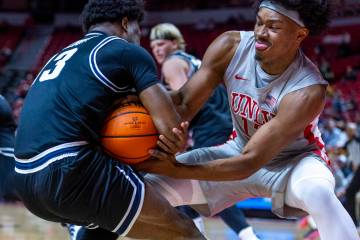 UNLV forward Jacob Bannarbie (12) fights for possession with Utah State Aggies guard Deyton Alb ...