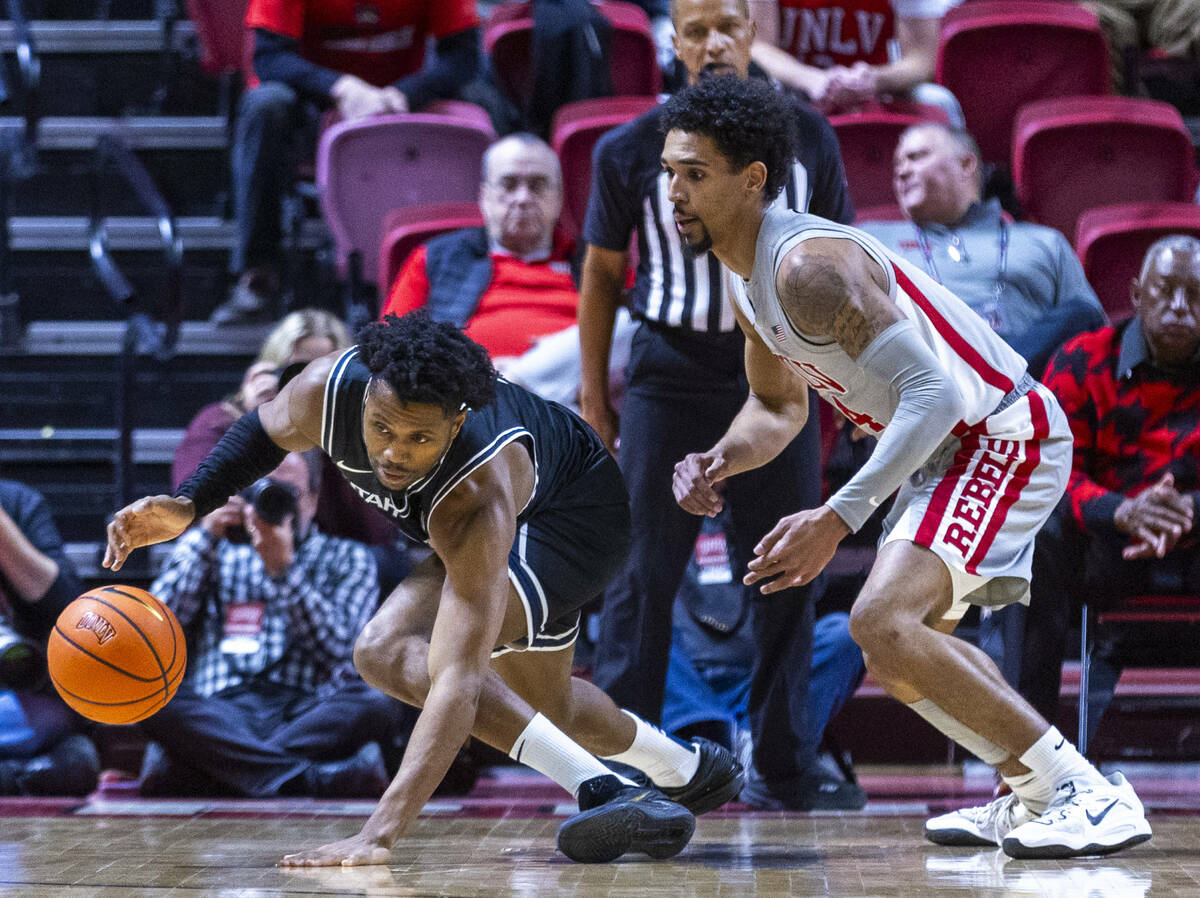 Utah State Aggies guard Dexter Akanno (7) loses the ball after a poke by UNLV guard Jailen Bedf ...