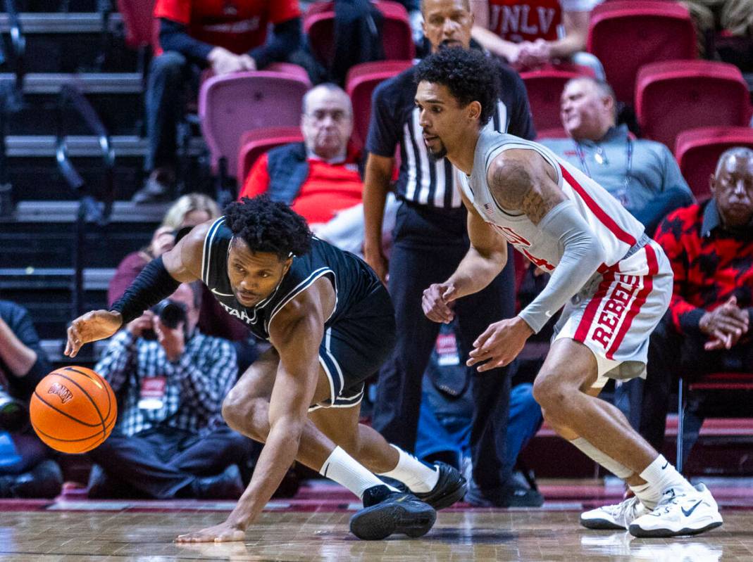 Utah State Aggies guard Dexter Akanno (7) loses the ball after a poke by UNLV guard Jailen Bedf ...