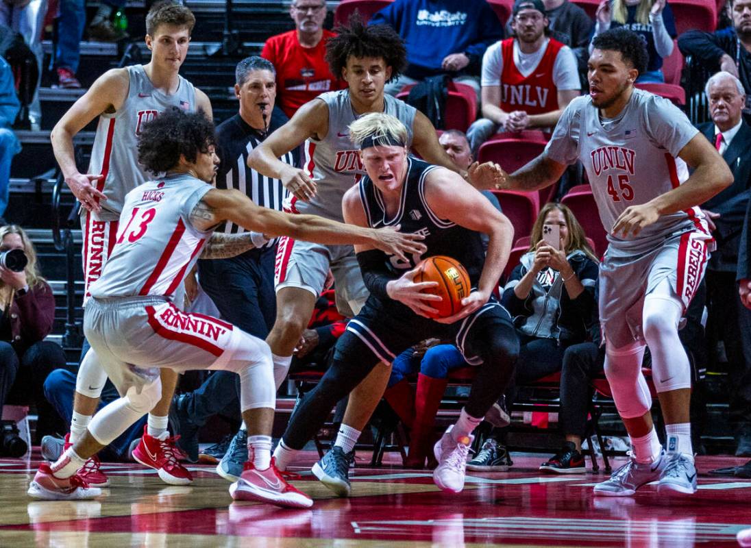 UNLV guard Brooklyn Hicks (13) looks to grab the ball from Utah State Aggies forward Karson Tem ...