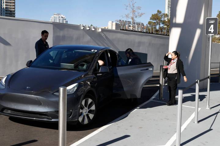 Passengers enter a Tesla at the Westgate's Vegas Loop station, an underground transportation sy ...