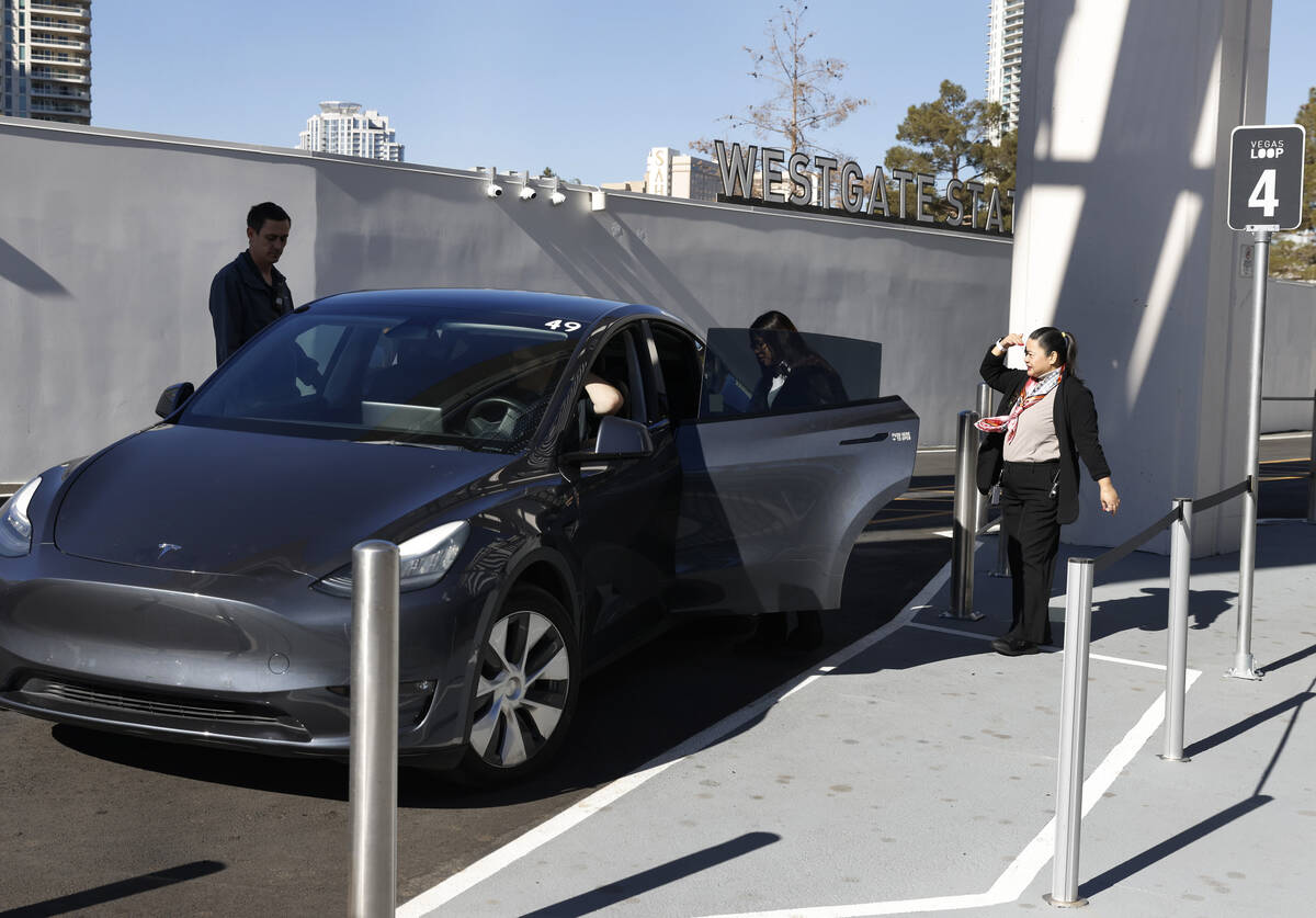 Passengers enter a Tesla at the Westgate's Vegas Loop station, an underground transportation sy ...