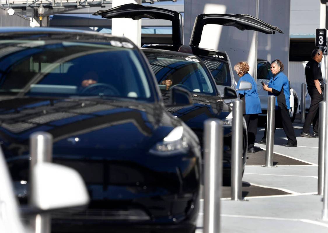 Passengers enter a Tesla at the Westgate's Vegas Loop station, an underground transportation sy ...