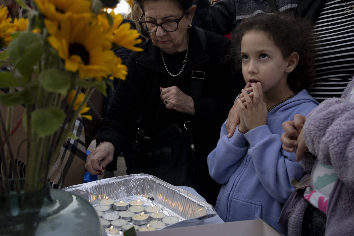 People gather to light candles for Shabbat in Tel Aviv, Israel, after Israel's security Cabinet ...