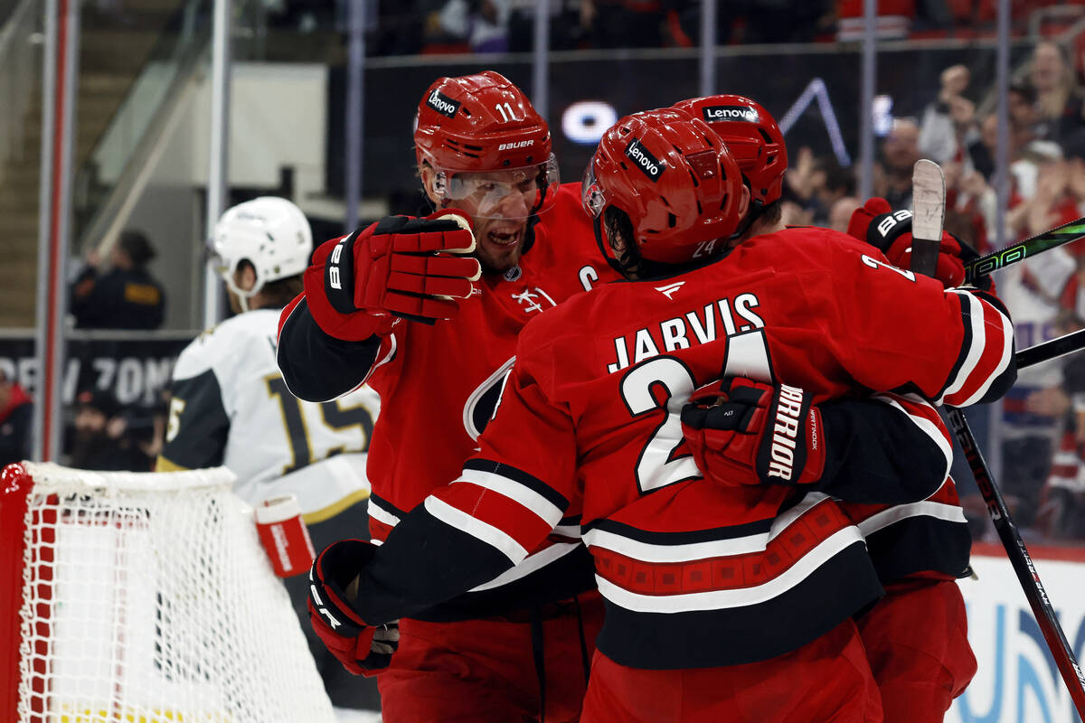 Carolina Hurricanes' Seth Jarvis (24) celebrates after his goal with teammates Jordan Staal, le ...