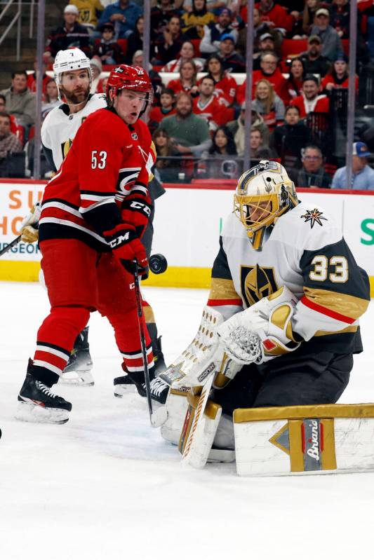 Vegas Golden Knights goaltender Adin Hill (33) blocks a shot as Carolina Hurricanes' Jackson Bl ...