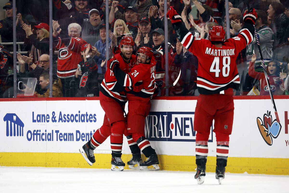 Carolina Hurricanes' Seth Jarvis (24) celebrates his goal with teammates Jordan Staal, left, an ...