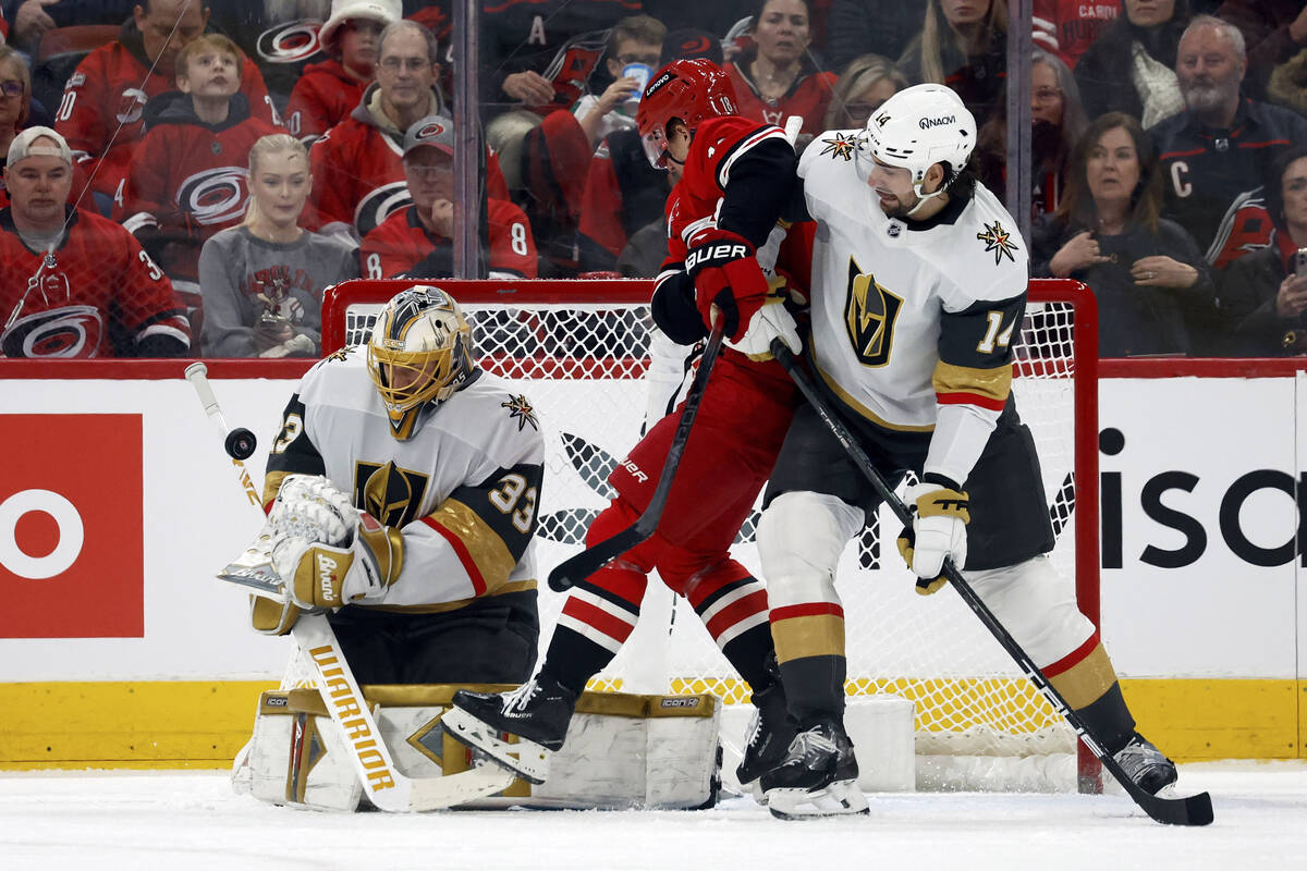 Vegas Golden Knights goaltender Adin Hill (33) blocks a shot with Carolina Hurricanes' Jack Dru ...