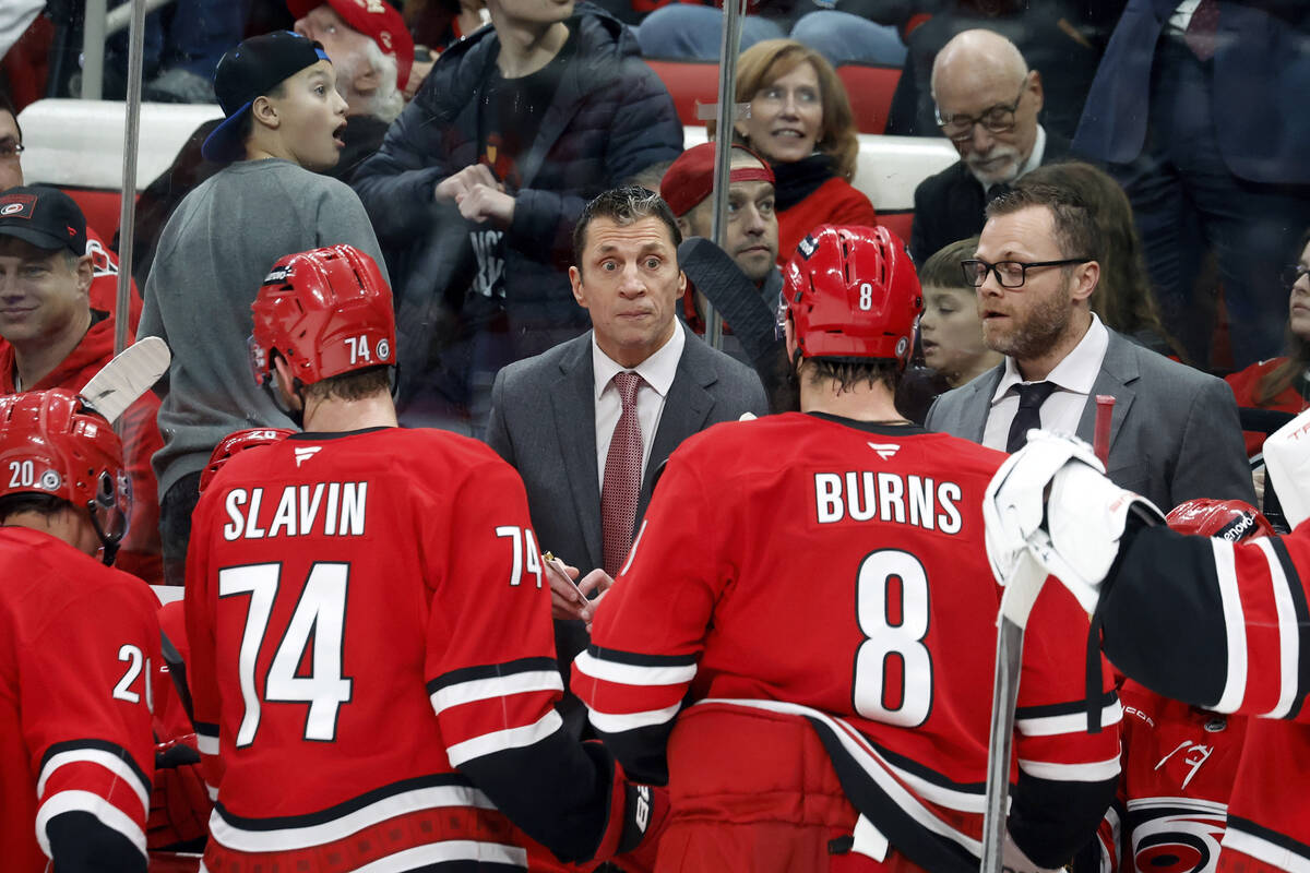 Carolina Hurricanes head coach Rod Brind'Amor, center, speaks to his team during a timeout in t ...