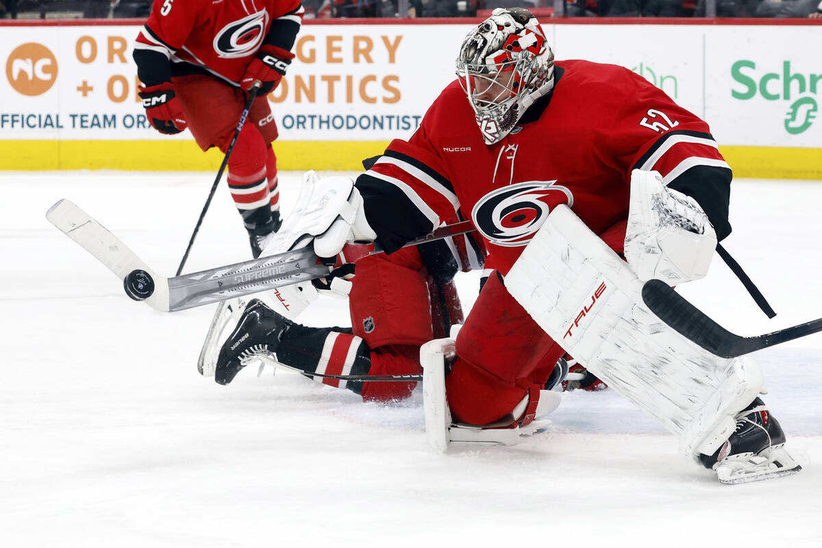 Carolina Hurricanes goaltender Pyotr Kochetkov (52) paddles the puck clear during the third per ...