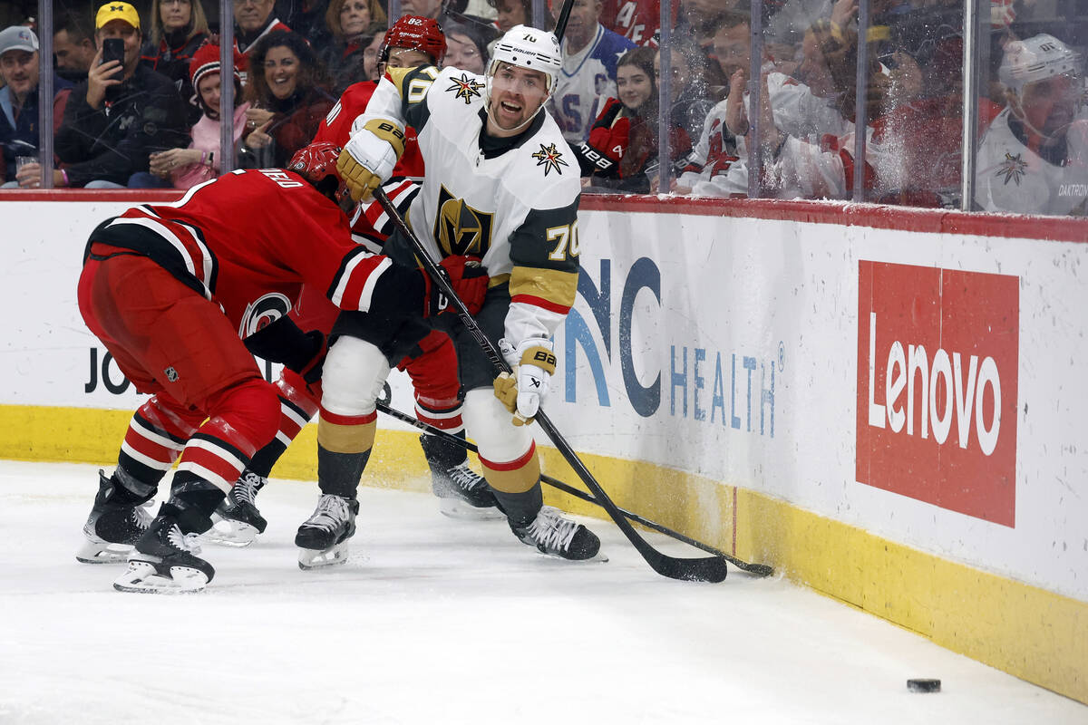 Vegas Golden Knights' Tanner Pearson (70) tries to break away from Carolina Hurricanes' Jalen C ...