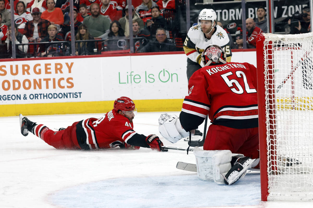 Carolina Hurricanes' Jordan Martinook (48) dives to the ice to snare the puck from Vegas Golden ...