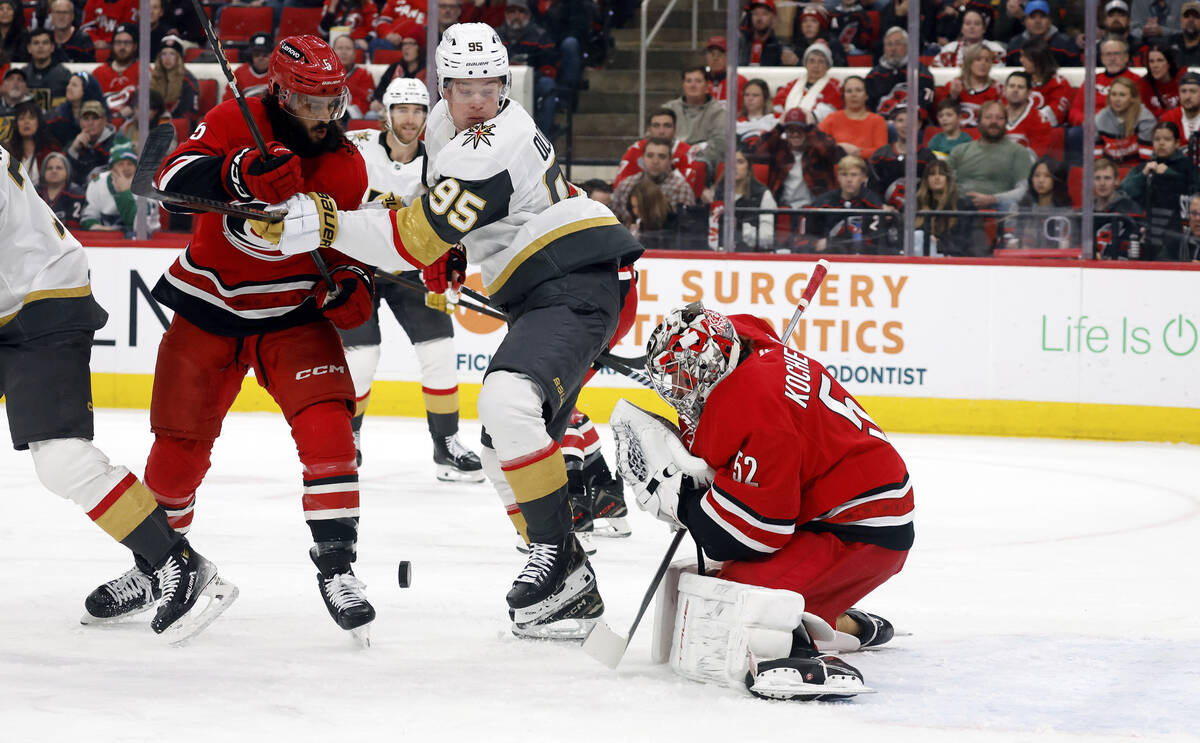 Vegas Golden Knights' Victor Olofsson (95) battles for the puck with Carolina Hurricanes' Jalen ...