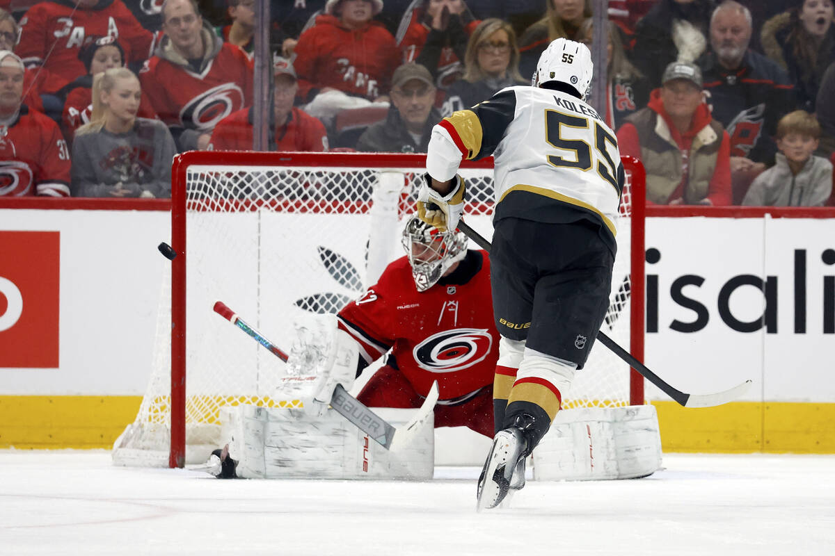 Carolina Hurricanes goaltender Pyotr Kochetkov, left, sends a penalty shot by Vegas Golden Knig ...