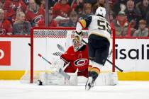 Carolina Hurricanes goaltender Pyotr Kochetkov, left, sends a penalty shot by Vegas Golden Knig ...