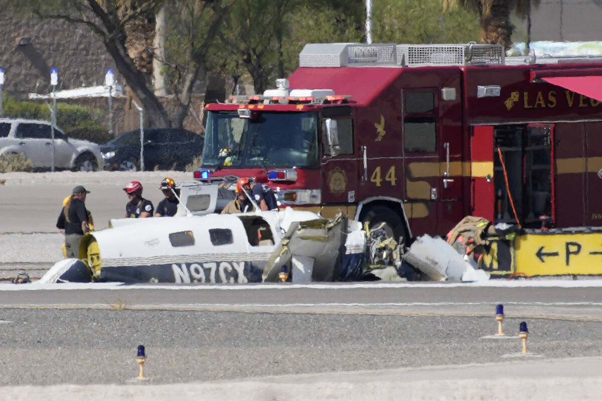 Officials investigate the wreckage of a plane at the site of a fatal crash at the North Las Veg ...