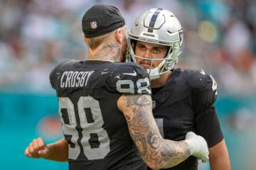 Raiders defensive end Maxx Crosby (98) hugs Raiders quarterback Aidan O'Connell (4) during the ...