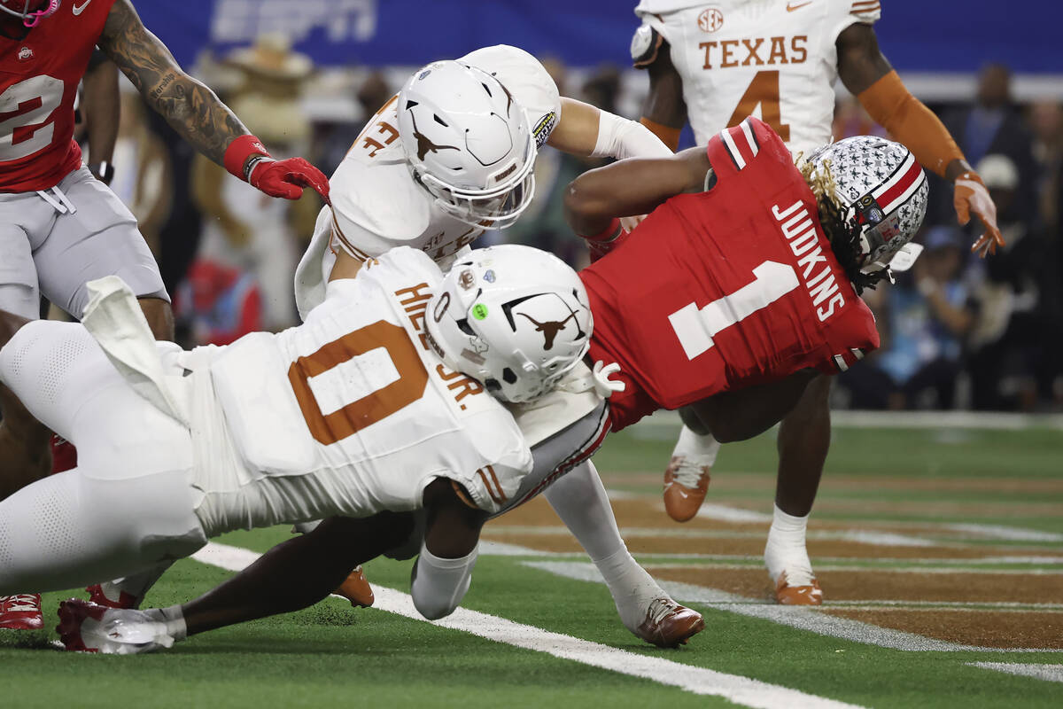 Ohio State running back Quinshon Judkins (1) scores past Texas defensive back Michael Taaffe, m ...