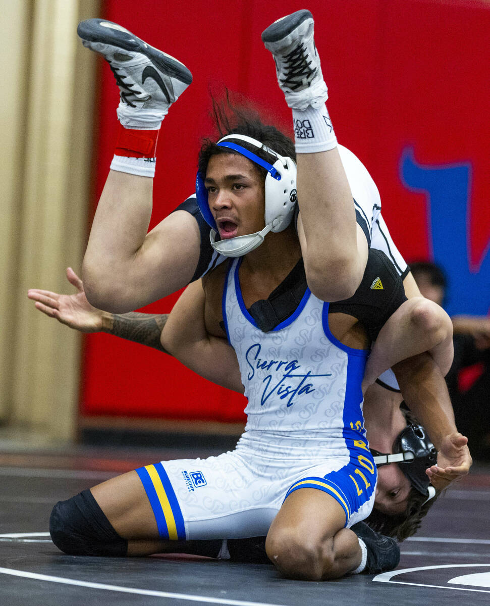 Sierra Vista's Makhi Clark is unclear what to do with SLAM's Eric Bice over his back during the ...