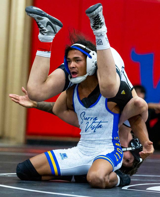 Sierra Vista's Makhi Clark is unclear what to do with SLAM's Eric Bice over his back during the ...