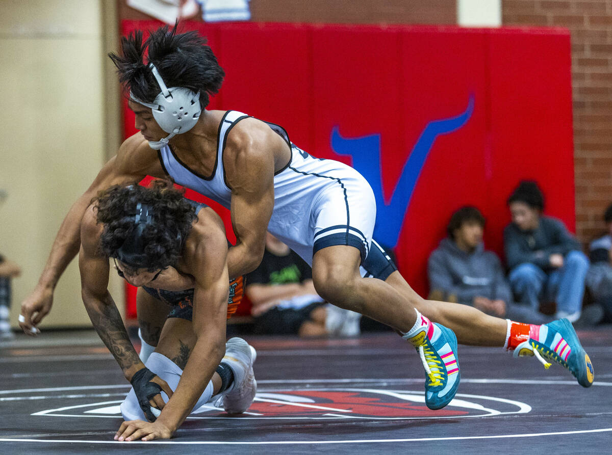 SLAM's Brenden Agcaolli takes Mojave's Isaiah Hill down to the mat during their 126 lb. finals ...