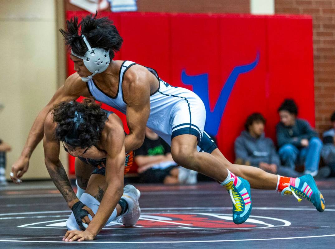 SLAM's Brenden Agcaolli takes Mojave's Isaiah Hill down to the mat during their 126 lb. finals ...