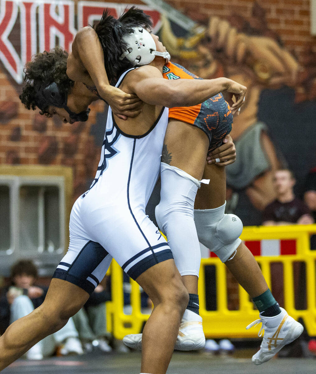 SLAM's Brenden Agcaolli lifts up Mojave's Isaiah Hill before driving him down to the mat during ...