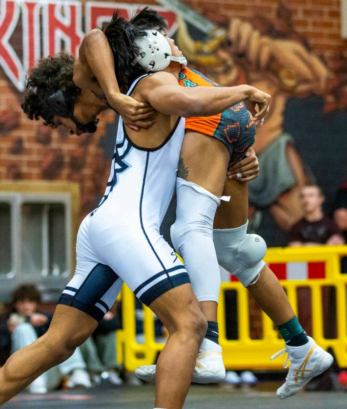 SLAM's Brenden Agcaolli lifts up Mojave's Isaiah Hill before driving him down to the mat during ...