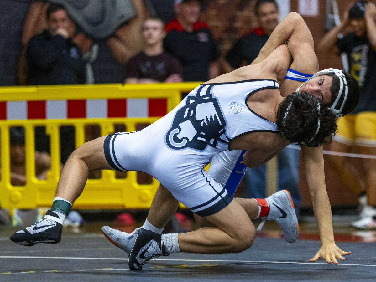 SLAM's Anthony Delgado battles to take down Sierra Vista's Sebastian Quintana to the mat during ...