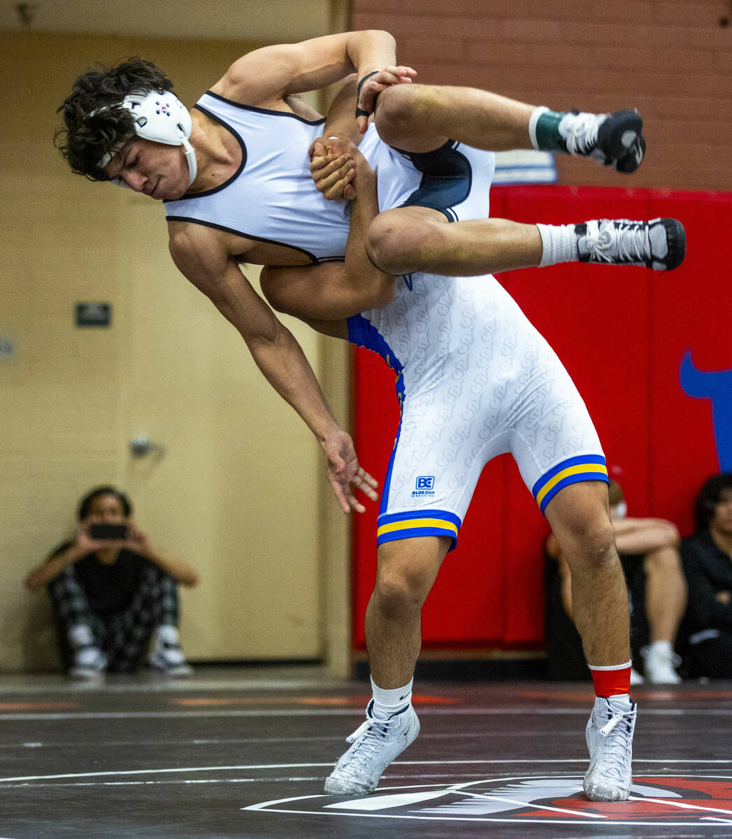 SLAM's Anthony Delgado is lifted into the air before taken down to the mat by Sierra Vista's Se ...