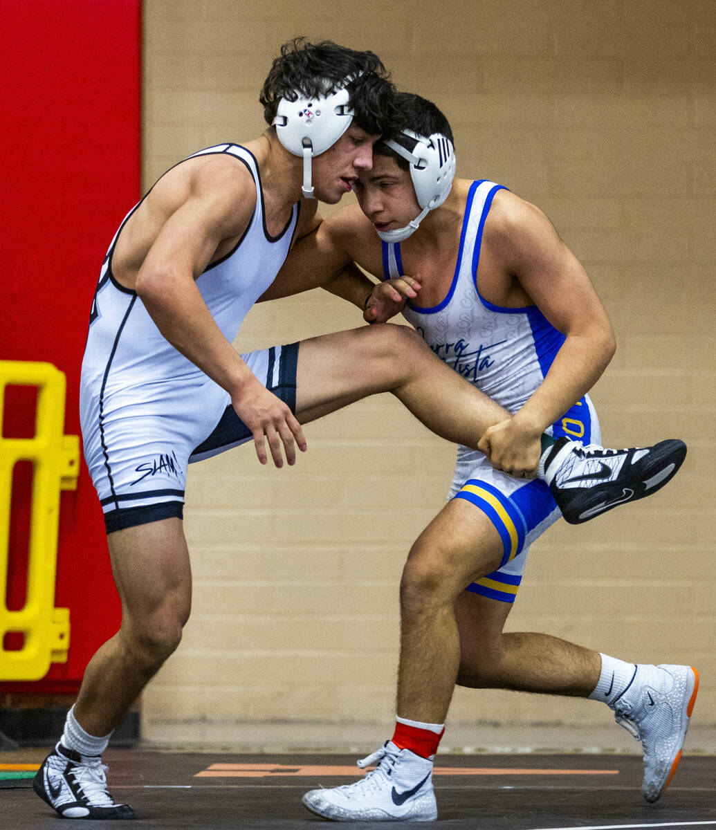 SLAM's Anthony Delgado battles to fight off a take down by Sierra Vista's Sebastian Quintana du ...