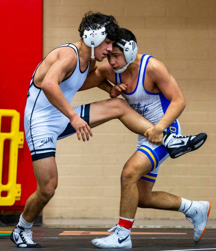 SLAM's Anthony Delgado battles to fight off a take down by Sierra Vista's Sebastian Quintana du ...