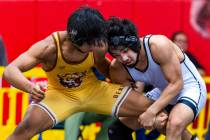 Bonanza's Kanye Ilai-Simio has his leg wrapped up by SLAM's Manuel Saldate during their 138 lb ...