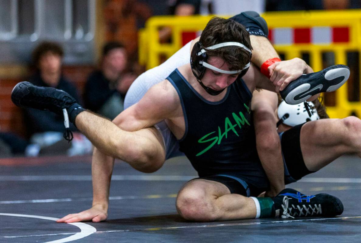 SLAM's Drake Hooiman flips Faith Lutheran's Cade Cook over his back on the mat during their 144 ...