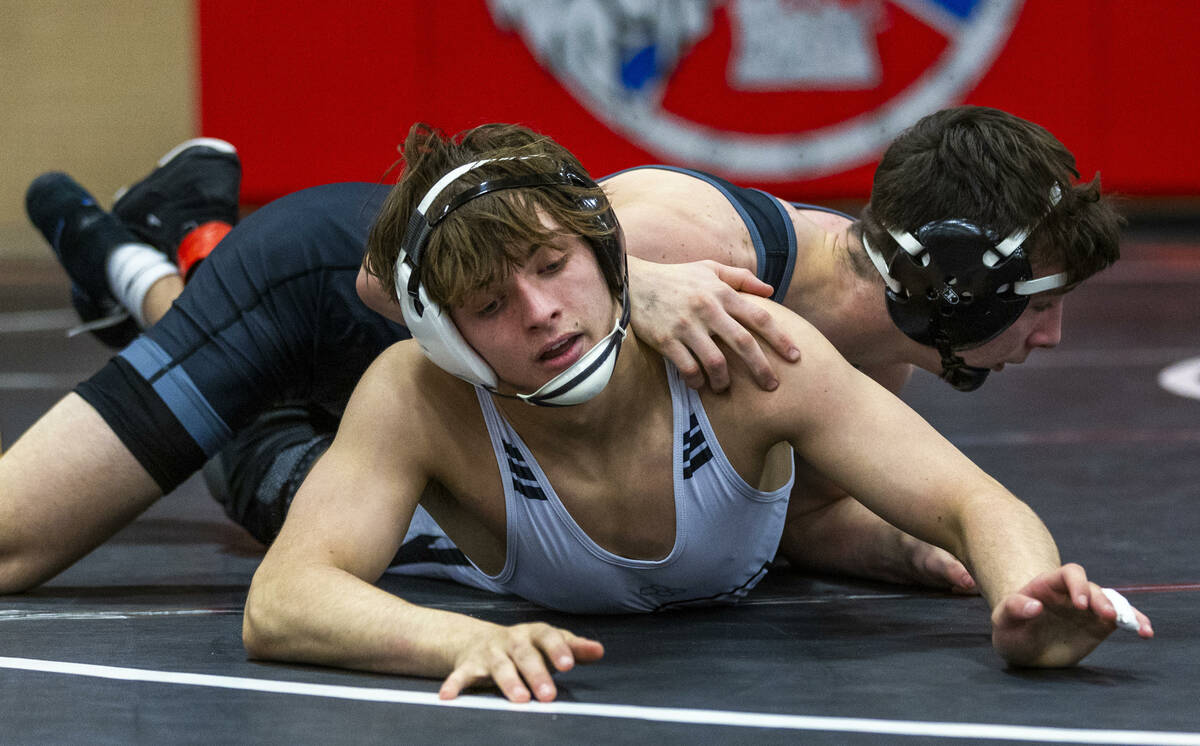 Faith Lutheran's Cade Cook works to escape a hold by SLAM's Drake Hooiman during their 144 lb. ...