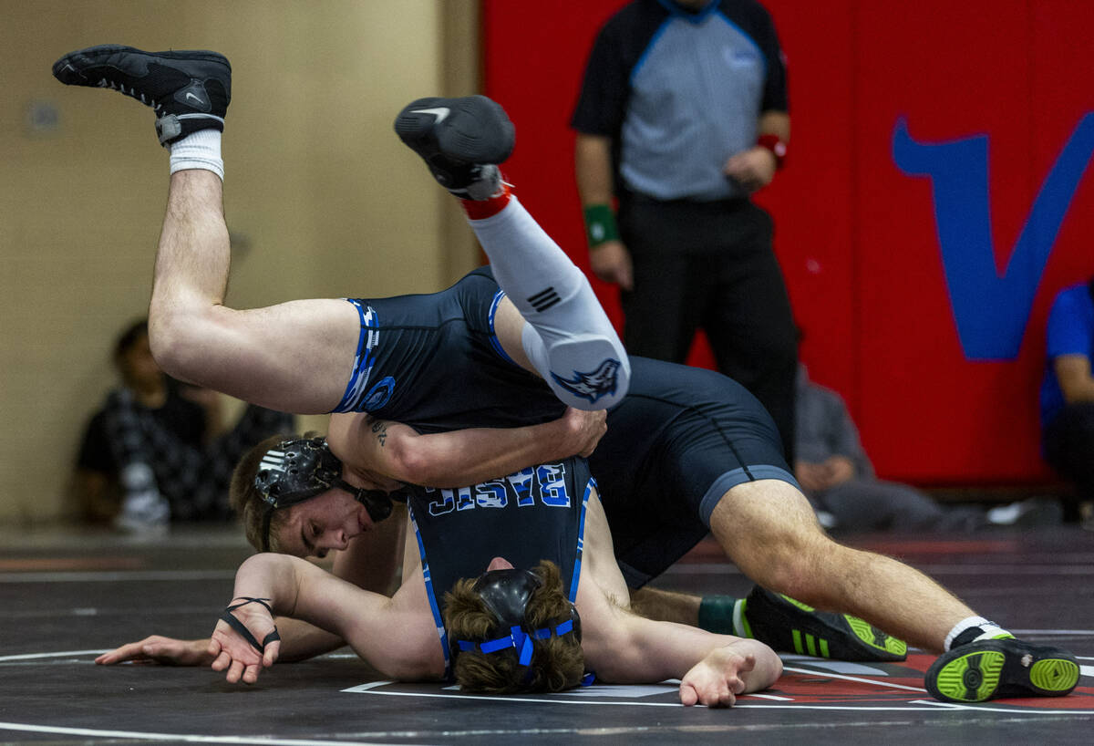 Basic's Jaxon Mackey is tossed upside down by SLAM's Isaac Balden during their 150 lb. finals m ...