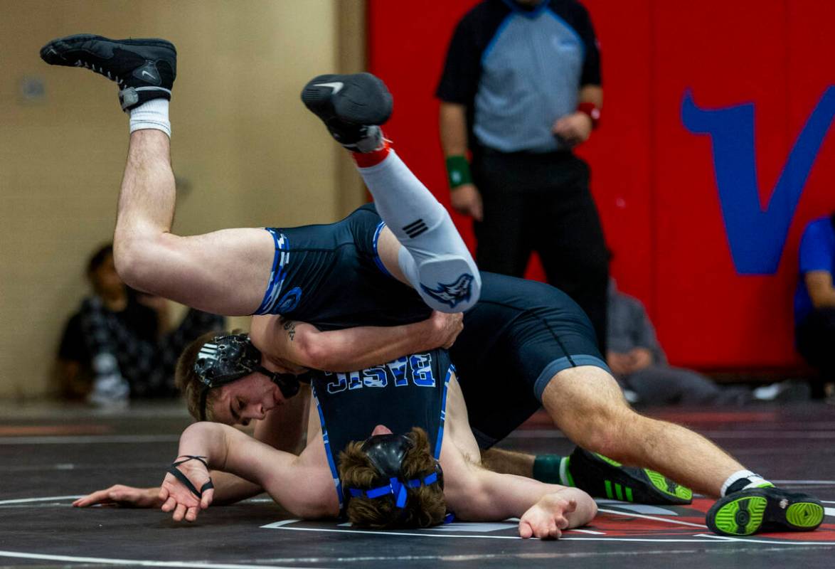 Basic's Jaxon Mackey is tossed upside down by SLAM's Isaac Balden during their 150 lb. finals m ...