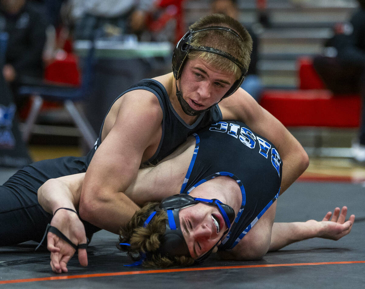 SLAM's Isaac Balden works to pin Basic's Jaxon Mackey during their 150 lb. finals match in the ...